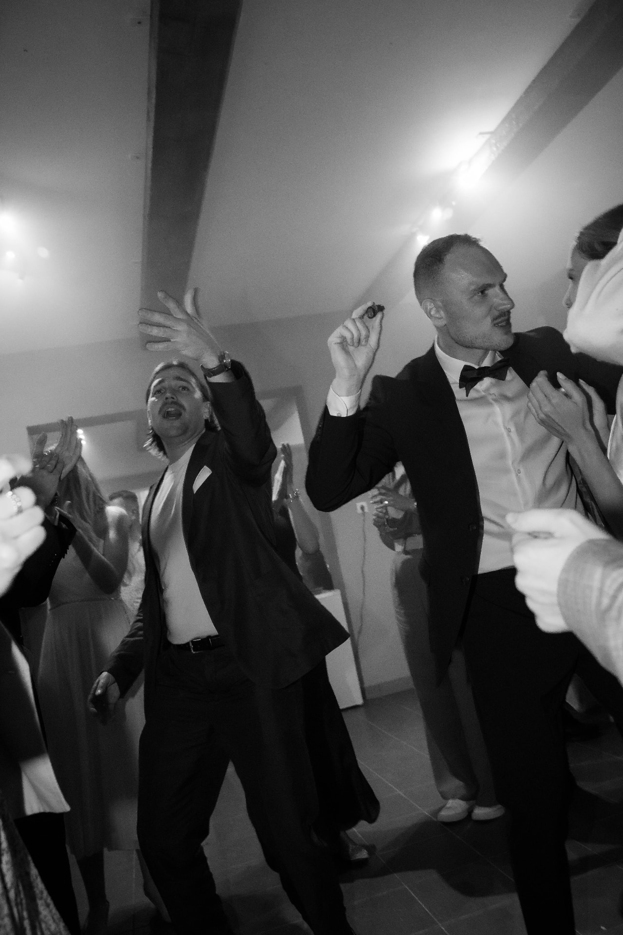 Guests dancing at the wedding party, black and white