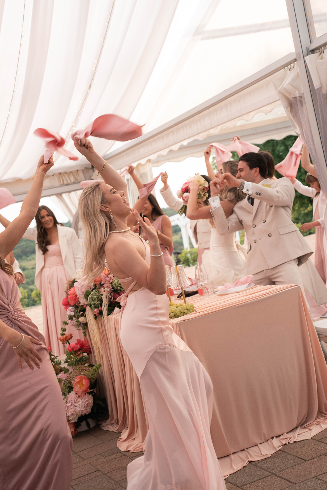 Wedding guests dancing with napkins in the marquee